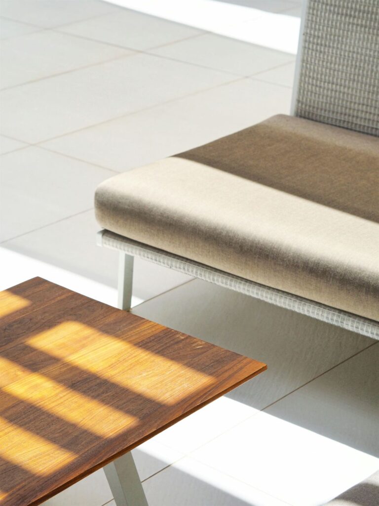 Designed for sun-soaked lounges or stylish patios, this modern outdoor coffee table features a striking checkered wood surface that plays beautifully with light and shadow. Its low profile and sharp edges bring a touch of