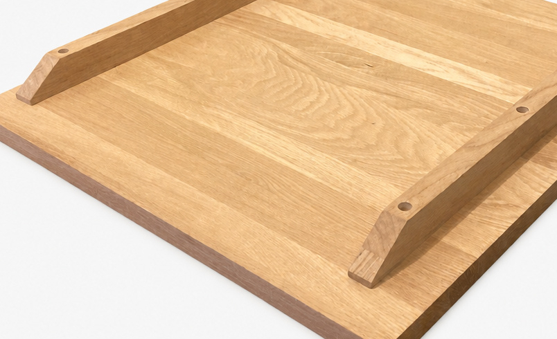 Straightening bars fitted beneath a solid oak table top